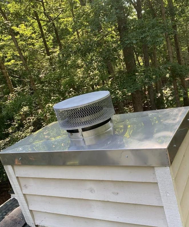 Custom stainless chimney chase cover and cap installed by Lounsbury Roofing