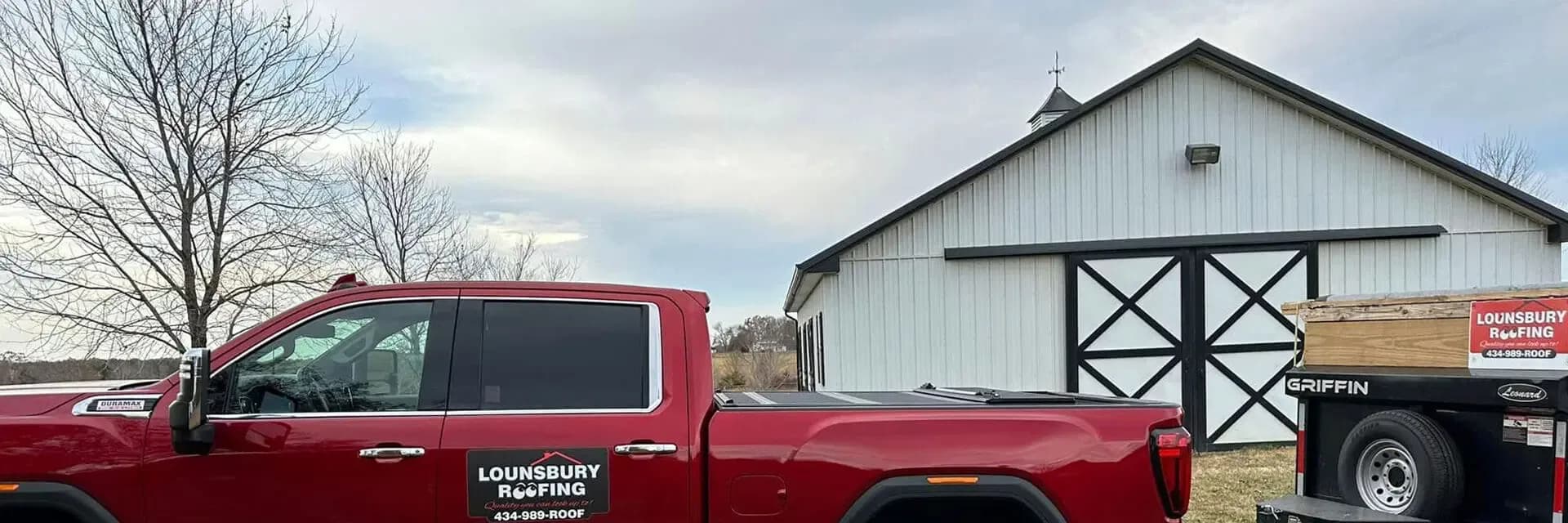 Lounsbury Roofing red truck and pole barn at the Palmyra, Virginia headquarters