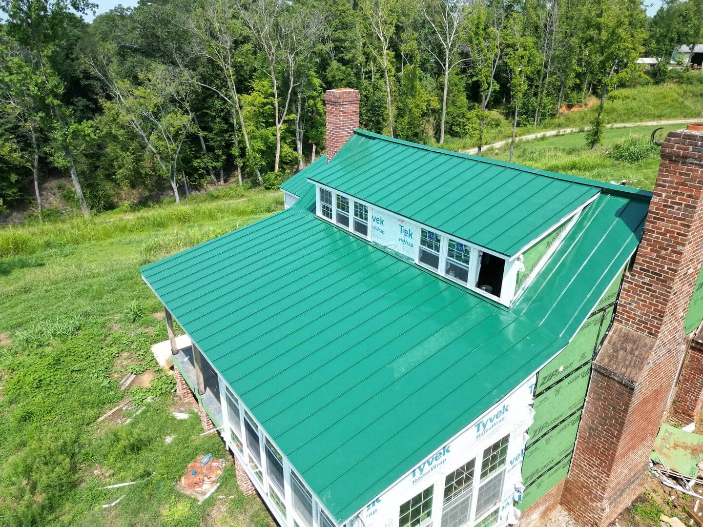 Standing-seam green metal roof installed by Lounsbury Roofing on a rural Madison-area home