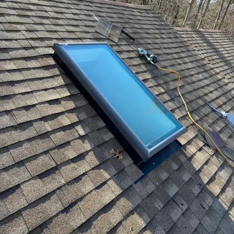 New skylight installed on shingled roof by Lounsbury Roofing